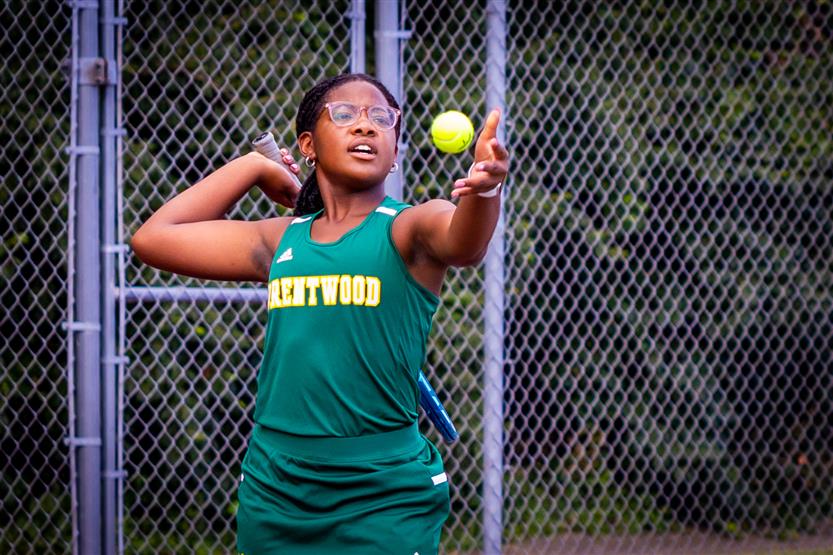 A tennis player serves the ball